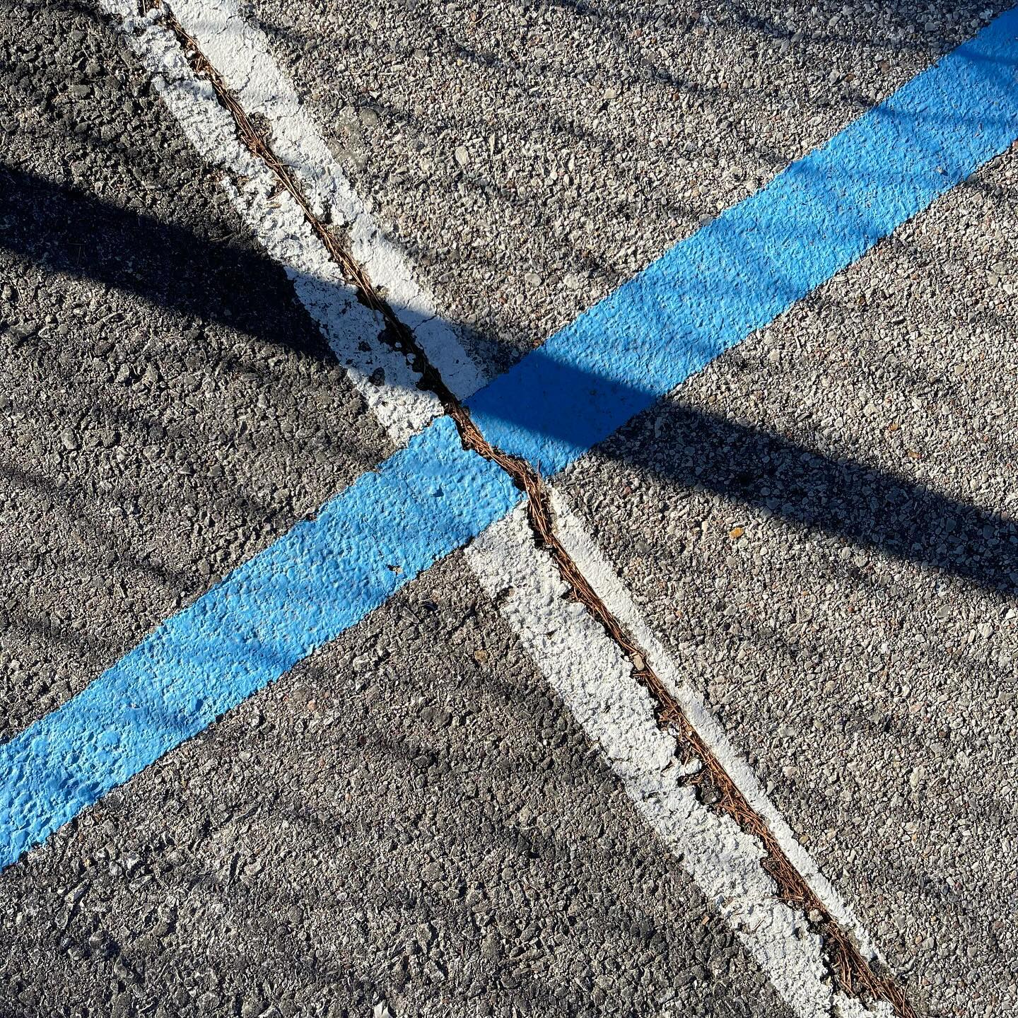 pavement, lines, fence shadows