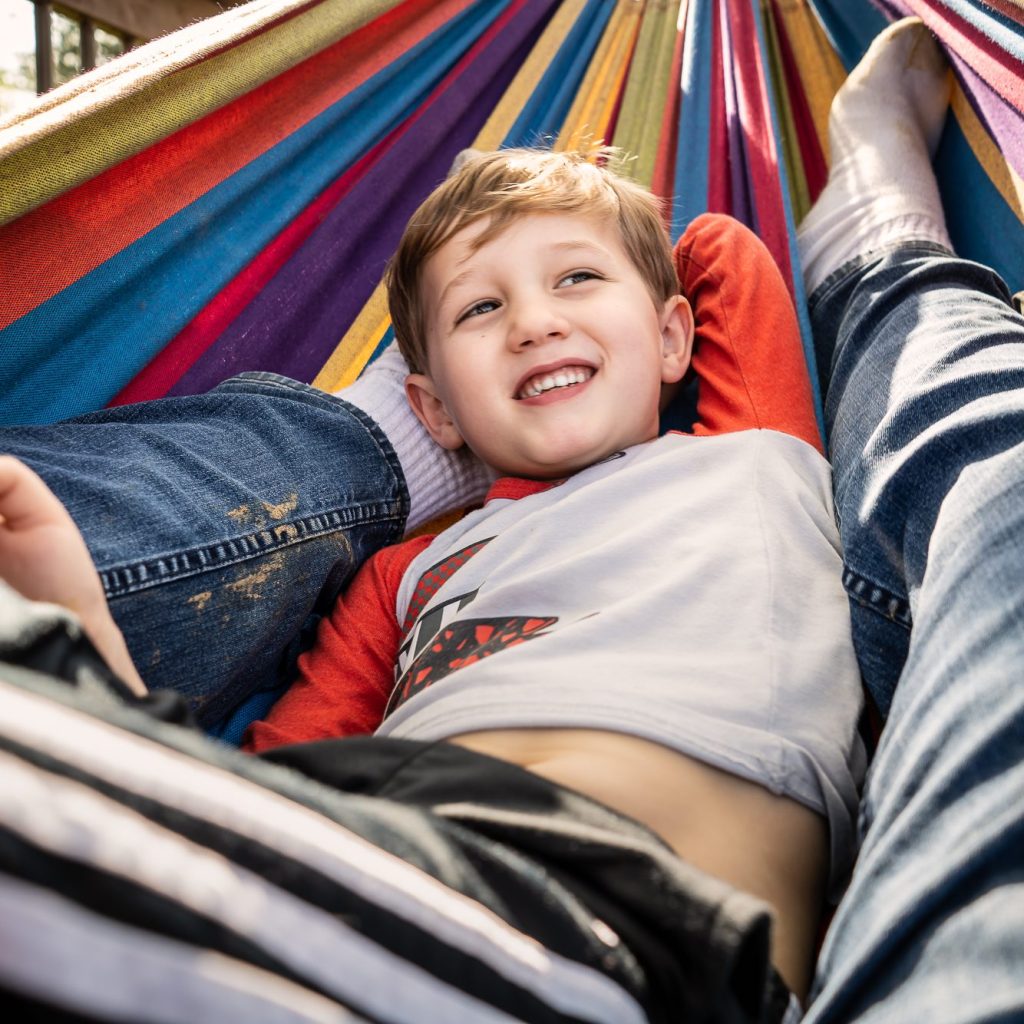 Boy in colorful hammock with dad, Bill Sawalich Quarantine Photo Diary 2020-31